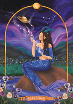 Illustration of a woman in a blue dress with a Capricorn zodiac sign, set against a starry night sky.