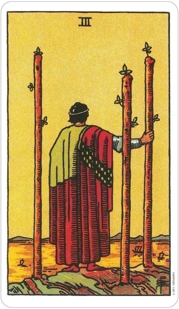 Tarot card with a figure holding two upright sticks on a yellow background