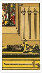 Tarot card with three swords and a figure lying on the ground