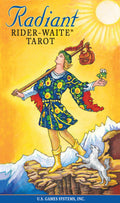 Cover of 'Radiant Rider-Waite Tarot' with a person in colorful clothing and a goat on a mountainous background.