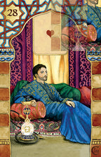 Man in ornate clothing sitting on a couch with decorative elements and a card in the background