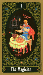 Tarot card featuring 'The Magician' with a magus at a table, surrounded by decorative elements.