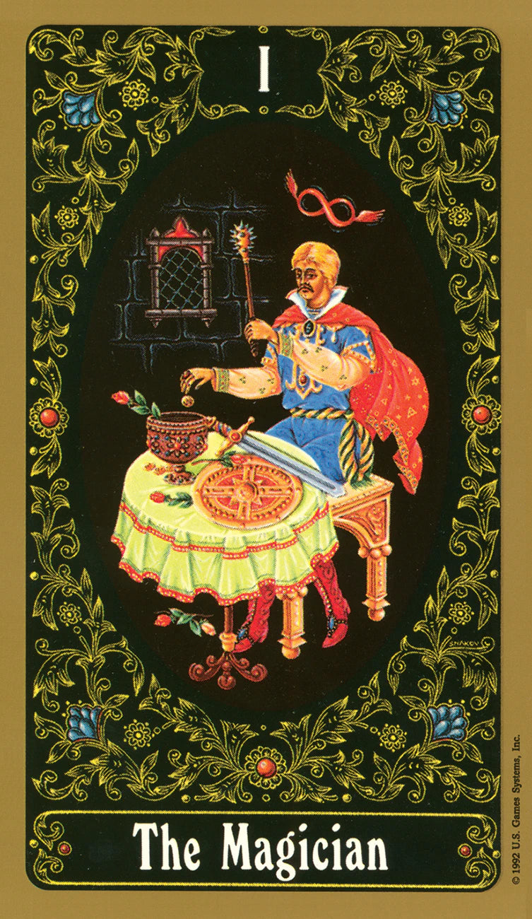 Tarot card featuring 'The Magician' with a magus at a table, surrounded by decorative elements.