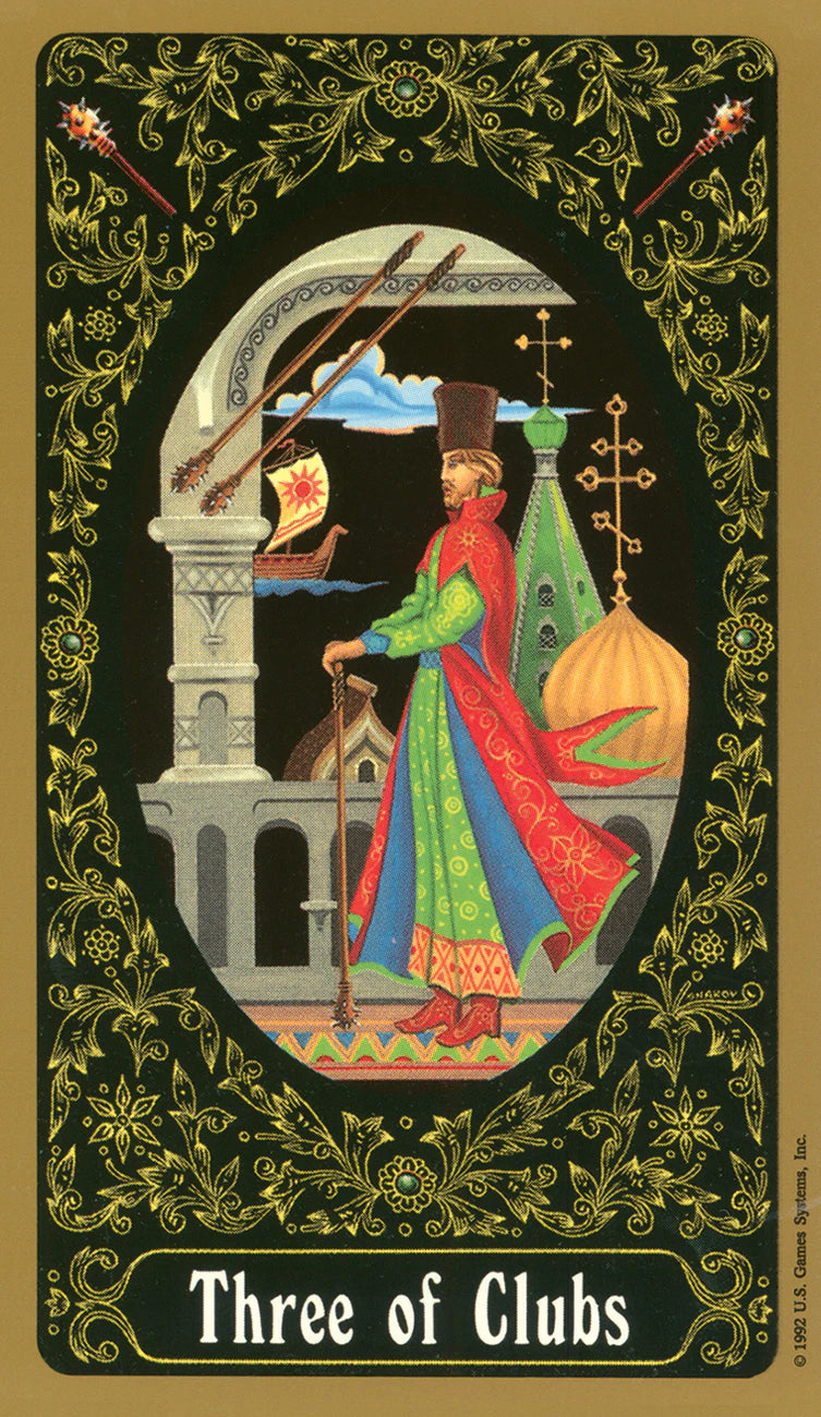 Card featuring a character in a colorful outfit with architectural elements and decorative border, labeled 'Three of Clubs'.