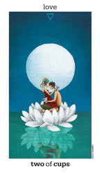 Tarot card titled 'Two of Cups' with two people embracing under a large moon on a white flower against a blue background.