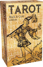 Box of Tarot cards with black and gold design on a beige background