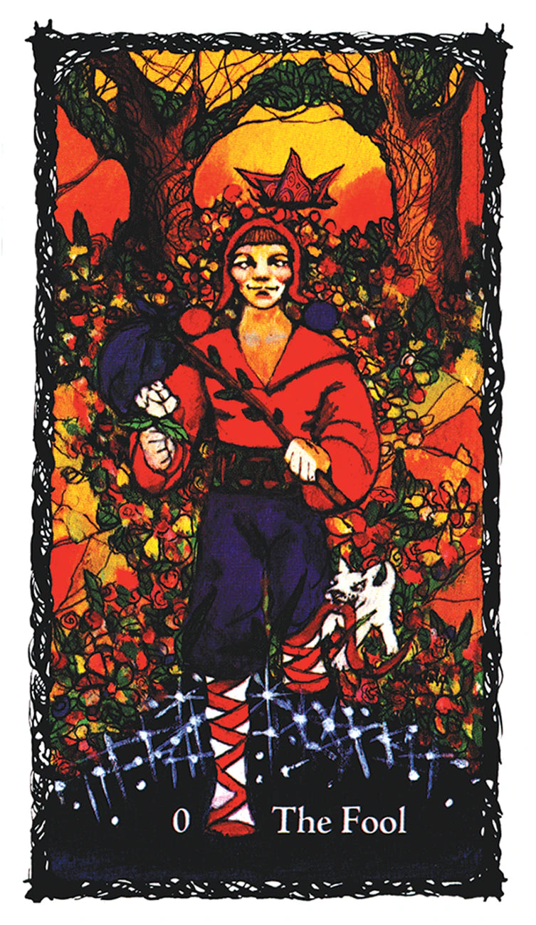 Tarot card featuring 'The Fool' with a person in a red robe and black hat in a forest setting.