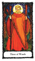 Tarot card featuring a figure in a red robe holding wands, with decorative border and 'Three of Wands' text at the bottom.