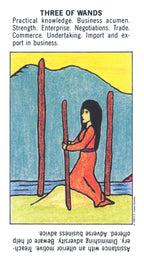 Tarot card with a woman standing between three upright wands against a mountain and sky background.
