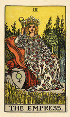 Tarot card featuring 'The Empress' with a woman in a floral dress sitting on a rock.
