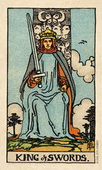King of Swords tarot card with a figure holding a sword against a blue sky.