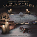 Promotional image for 'Tabula Mortem' with a skull, candles, and a spirit board on a dark background.