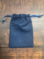 Blue drawstring pouch on a wooden surface