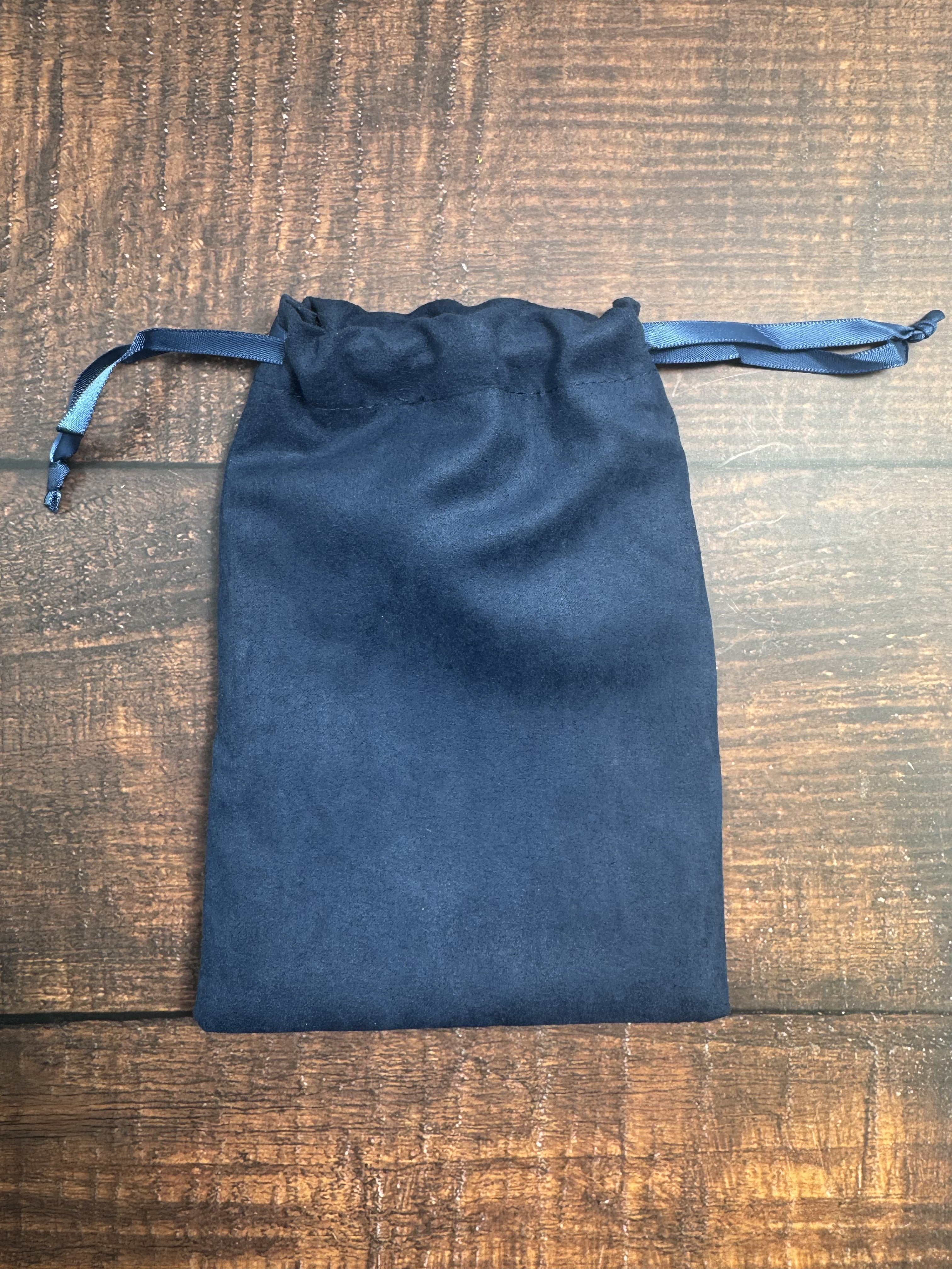 Blue drawstring pouch on a wooden surface