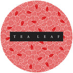 Circular red and white patterned label with 'TEA LEAF' text