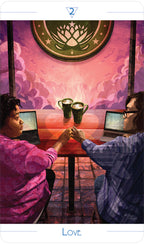 Two people sitting at a table with laptops, clinking mugs against a pink wall with a logo.