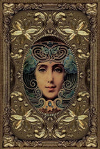 Decorative artwork with intricate designs and a central face in an ornate frame.