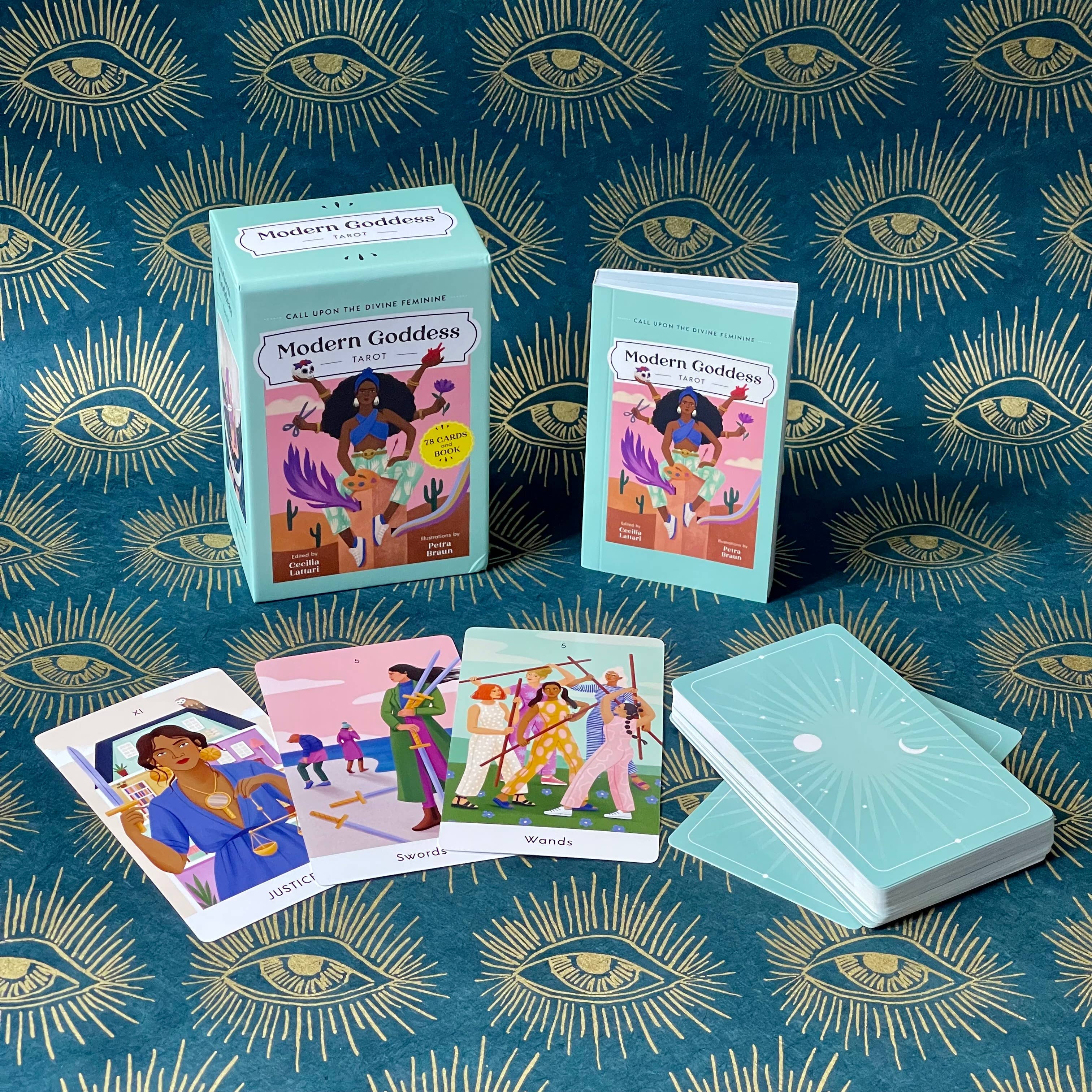 Modern Goddess tarot cards on a blue background with eye designs