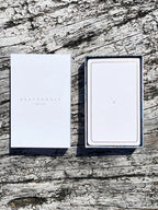 Two white boxes with 'DEATH BY AIR' branding on a textured wooden surface