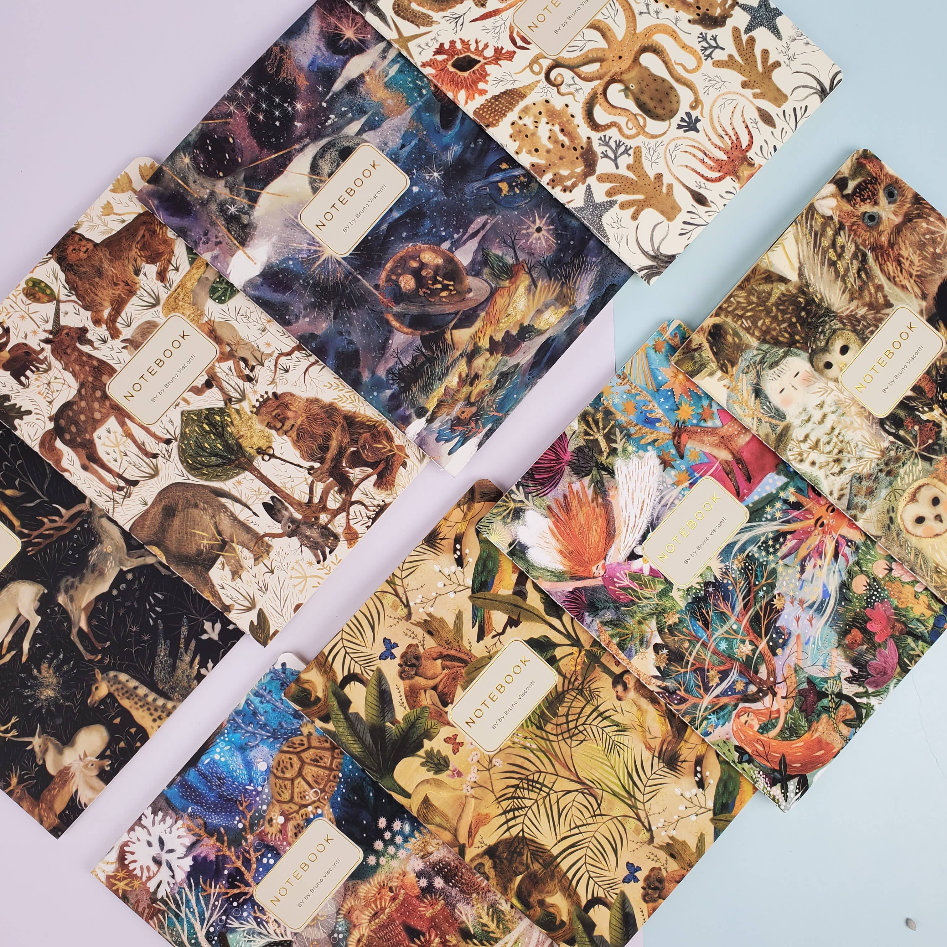 Collection of notebooks with various animal-themed covers on a light blue background