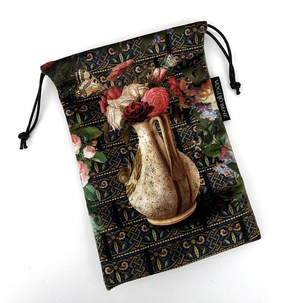 Decorative pouch with floral design and a vase of flowers on a white background