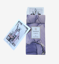 Amethyst Tarot deck by Nola James, featuring a lavender and purple marble-patterned box with a white label, shown alongside a tarot card on a light gray background.
