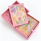 The Plant Guardians Oracle card deck in its pink box, shown open with the lid leaning on top and one card titled 'Ginger' visible inside. The box lid features colorful botanical illustrations and the text 'SOW THE MAGIC' and 'PLANT GUARDIANS ORACLE'.
