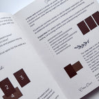 Open book with crystal card reading instructions and symbols on a white background
