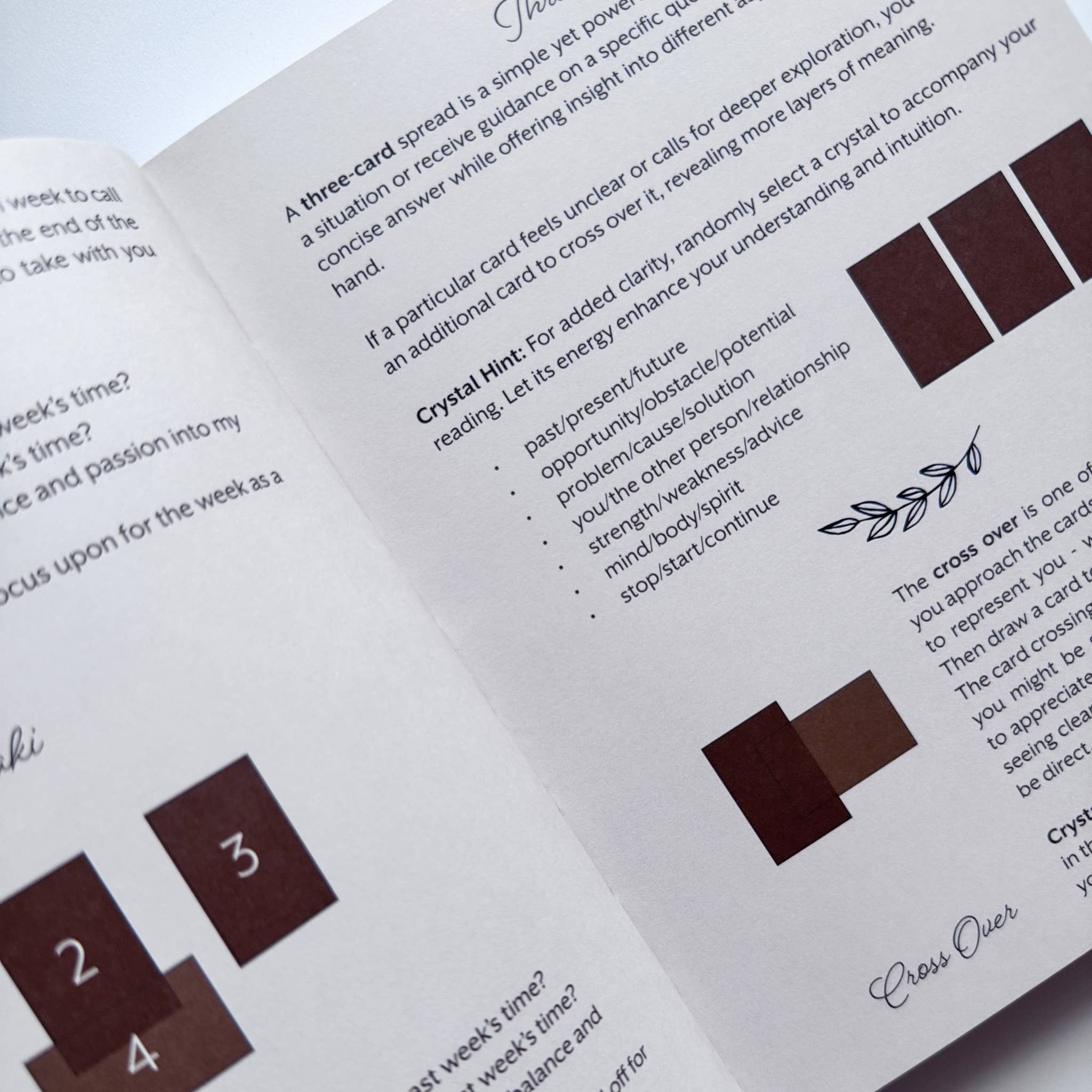Open book with crystal card reading instructions and symbols on a white background