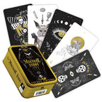 Playing cards with black and white designs in a yellow tin box