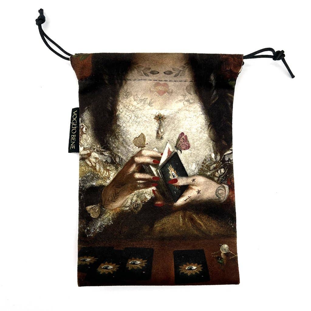 Drawstring bag with a design of a person's hands holding playing cards against a white background