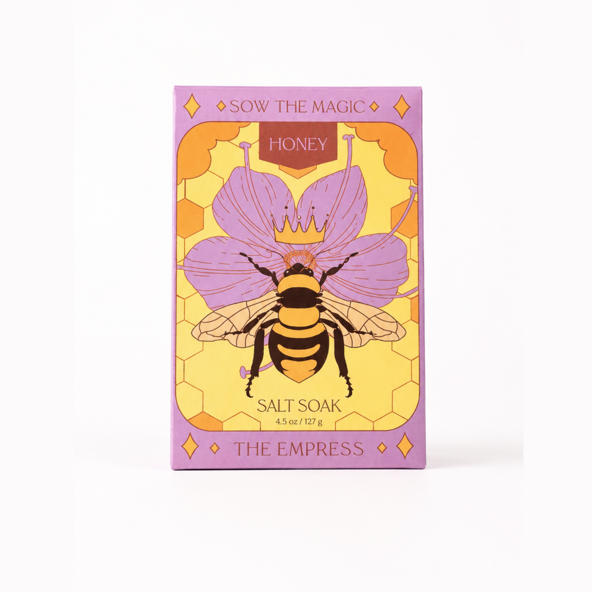 A rectangular product box for 'Sow the Magic: The Empress' Honey Salt Soak, featuring a purple and yellow design with an illustration of a honeybee on a flower.