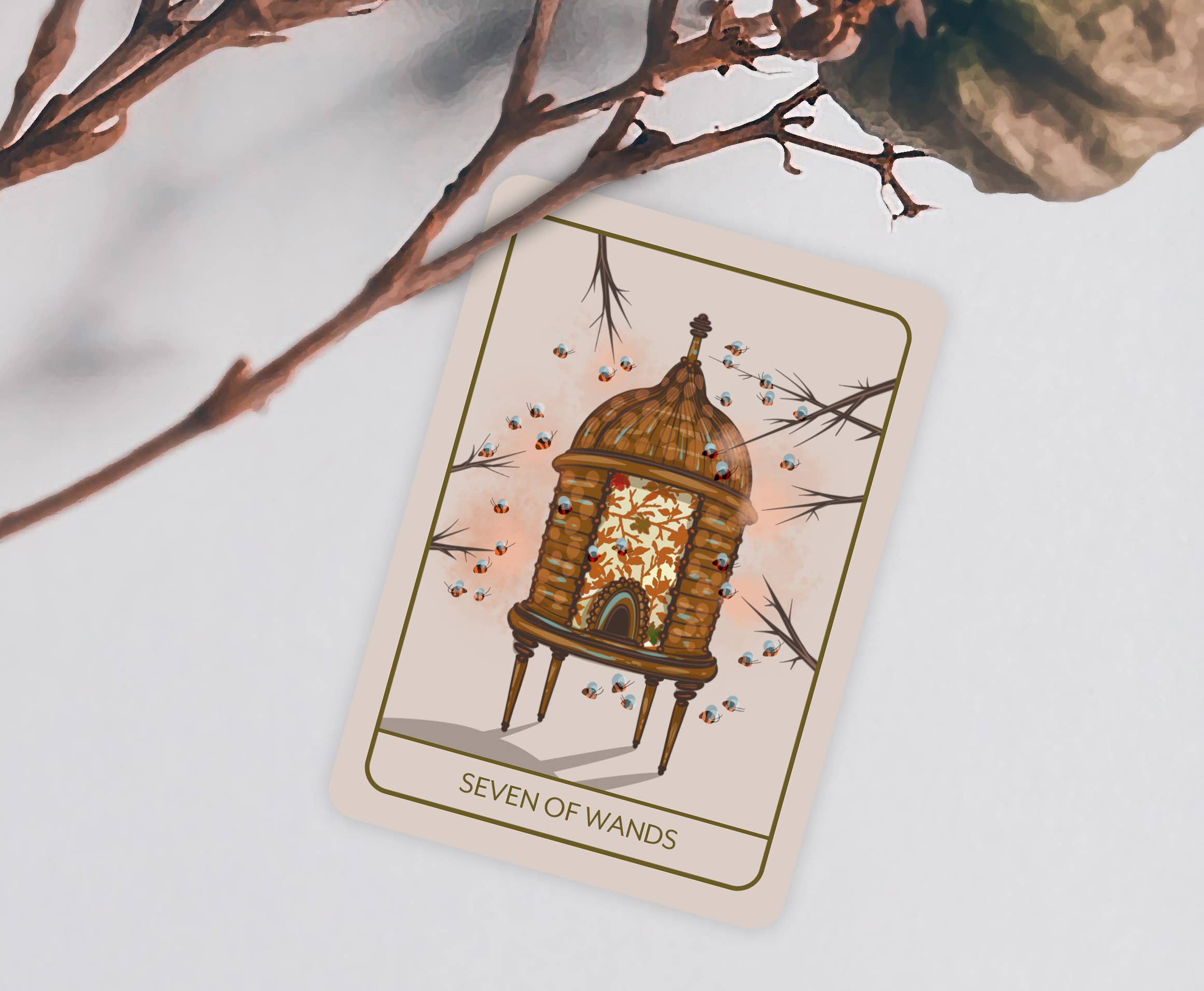 A tarot card titled 'Seven of Wands' featuring an illustration of a glowing lantern inside a wooden cage, styled on a light gray surface with decorative branches.