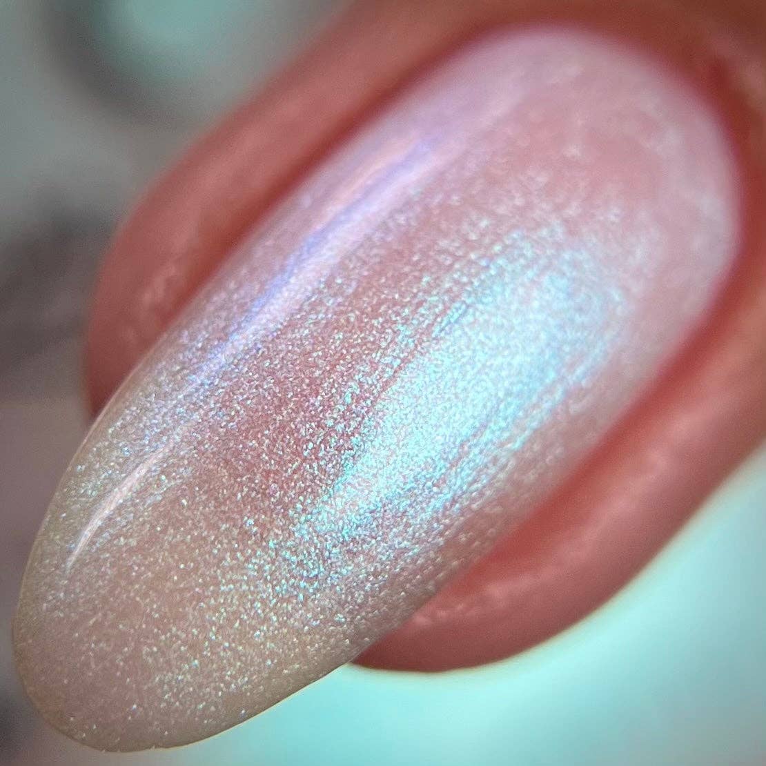 Close-up of a glittery lip gloss on a blurred background