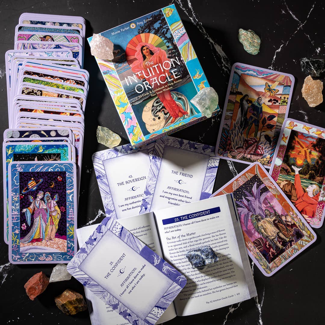 Inuition Oracle cards on a dark surface with crystals around