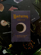 Nocturna Oracle card deck on a dark background with tarot cards