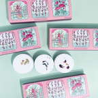 Set of shower steamers with decorative packaging on a light green background