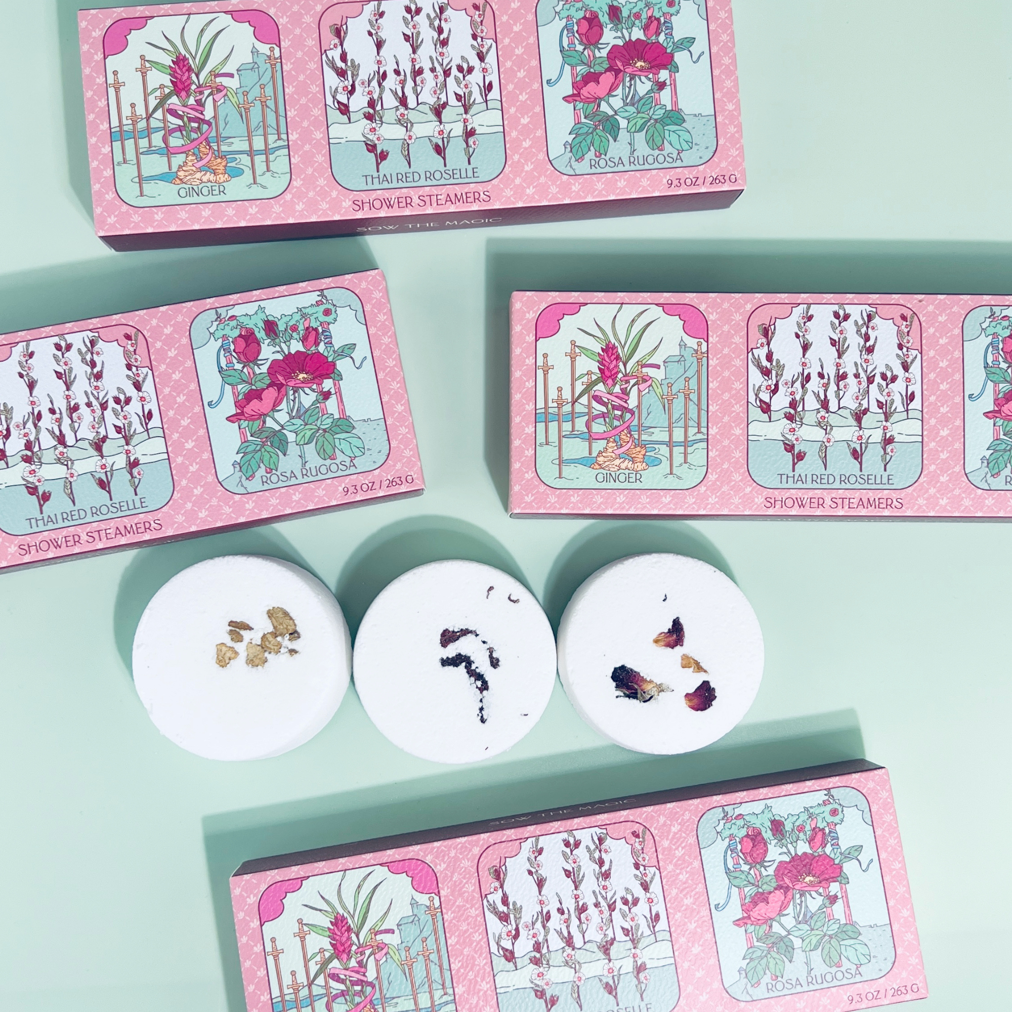 Set of shower steamers with decorative packaging on a light green background