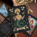 Tarot card featuring a Náñga with decorative elements on a wooden surface.
