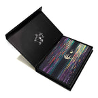 Open black box with colorful interior and decorative elements on a white background