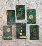 Set of tarot cards with astrological symbols on a textured surface