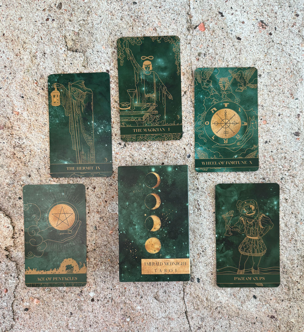 Set of tarot cards with astrological symbols on a textured surface