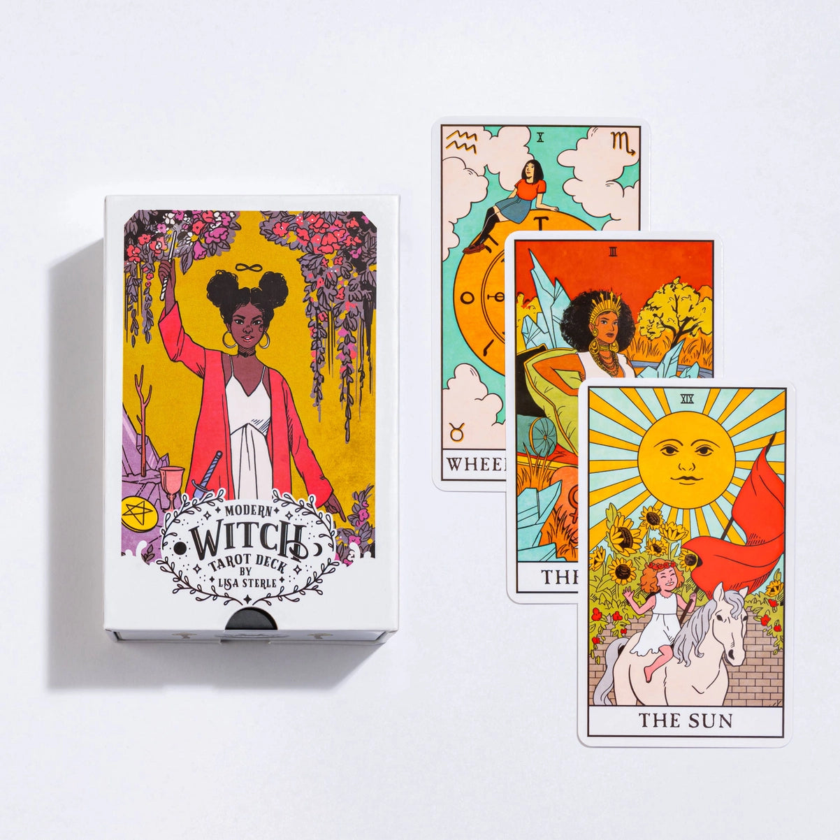 Box of 'Modern Witch' tarot cards with three tarot cards displayed on a white background.