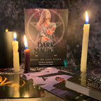 Book titled 'Dark Magic' by Fiona Horne with lit candles on a dark background