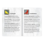 Book open to pages about canaries and cardinals with illustrations and text.