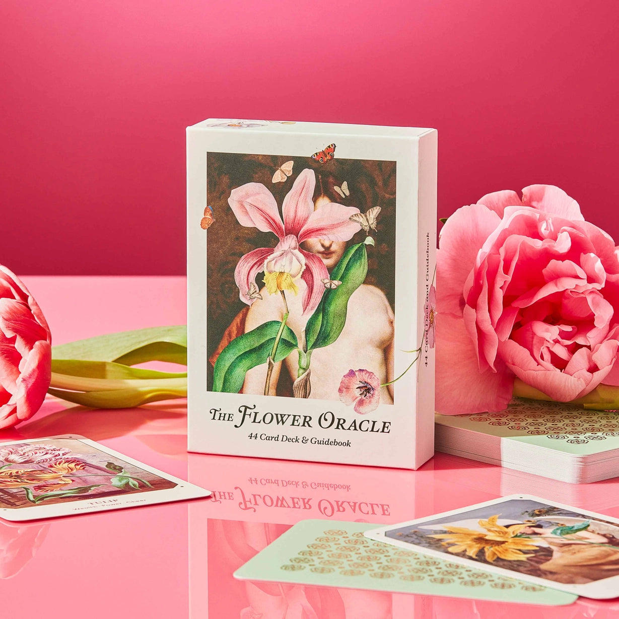 Flower Oracle card set with cards and packaging on a pink background