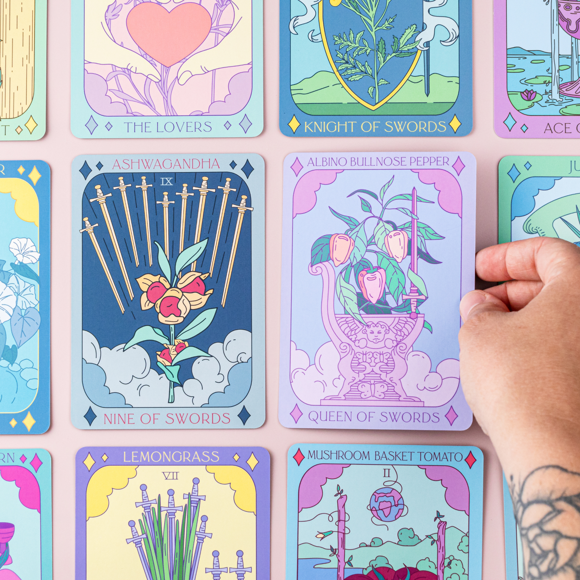Colorful tarot cards with a hand reaching for one card.