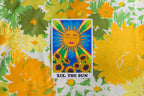 Tarot card featuring 'The Sun' with sunflowers on a floral background