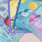 Colorful tarot cards with various symbols and designs on a light pink surface.