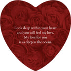 Heart-shaped arrangement of red roses with a romantic message on a white background